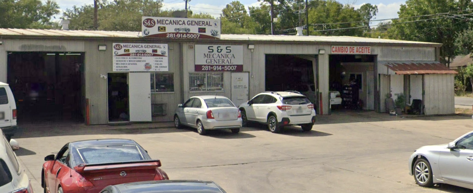S&S Auto Service shop in Houston — mechanic working under a lifted vehicle